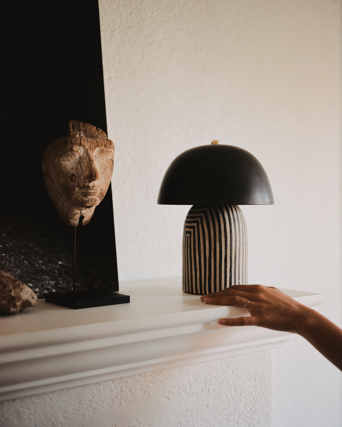 Ceramicah - Mini Tera Lamp in Stripe Finish with Black Shade on a mantelpiece 