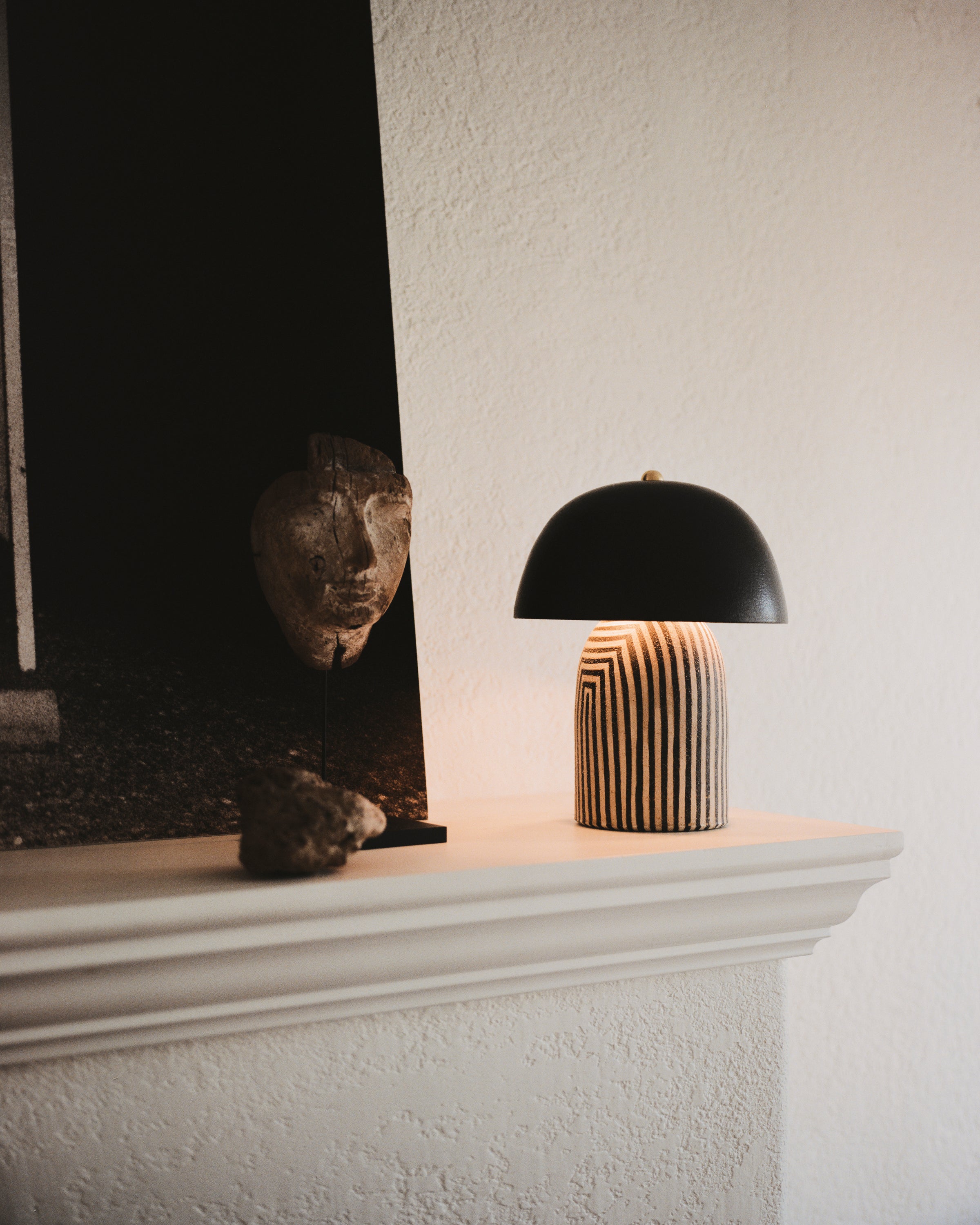 Ceramicah Tera Lamp mini in stripe with black shade on fireplace mantle