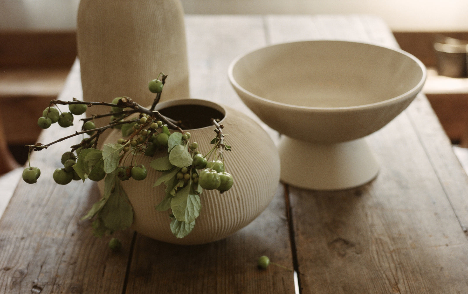 Ceramicah - Dune vessel collection in ribbed stone finish sitting on a kitchen table
